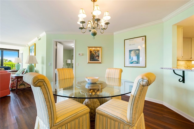 dining room with dark wood-type flooring, a notable chandelier, and ornamental molding