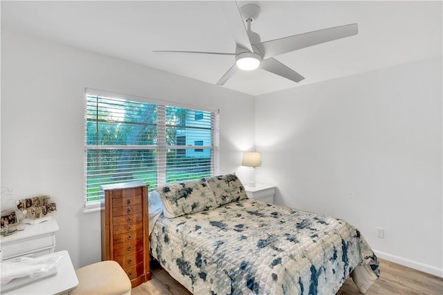 bedroom with light wood-type flooring and ceiling fan