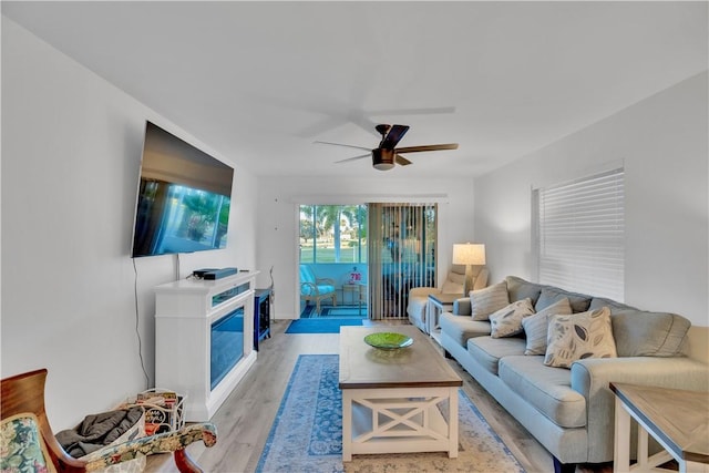 living room featuring light wood-type flooring and ceiling fan