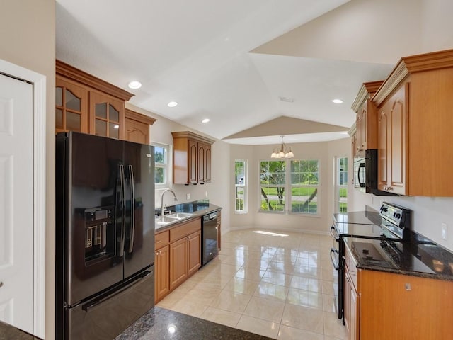 8340 Paladin Sq, Vero Beach, FL 32967 - kitchen featuring black appliances, a chandelier, lofted ceiling, glass insert cabinets, and hanging light fixtures