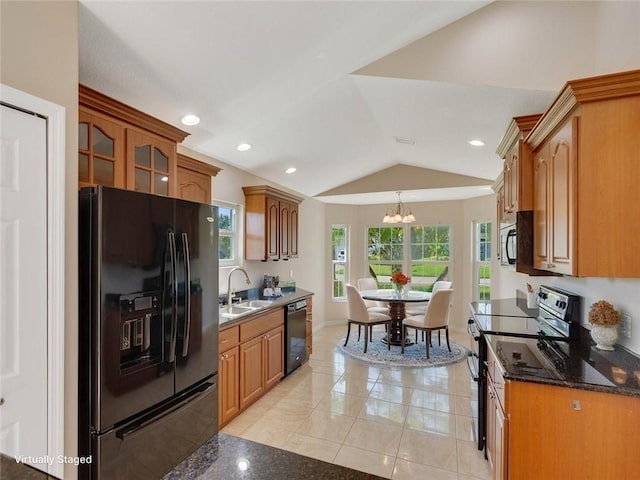 8340 Paladin Sq, Vero Beach, FL 32967 - kitchen with black appliances, a chandelier, lofted ceiling, light tile patterned flooring, and glass insert cabinets