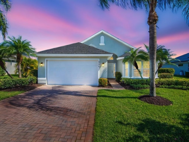 8340 Paladin Sq, Vero Beach, FL 32967 - ranch-style house featuring decorative driveway, stucco siding, a garage, and a yard