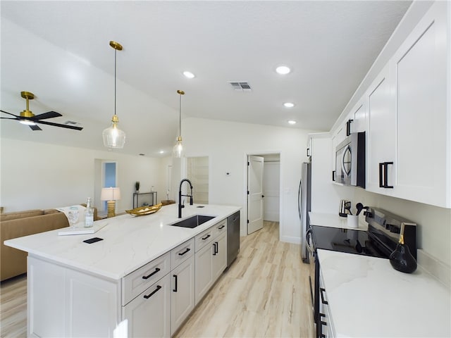 kitchen featuring a sink, stainless steel appliances, white cabinetry, vaulted ceiling, and visible vents