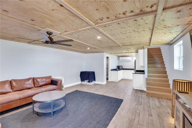 7205 Kamelya St SW, Vero Beach, FL 32968 - living area featuring a wall unit AC, stairs, wooden ceiling, baseboards, and light wood-style floors
