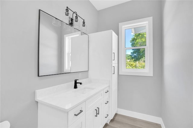 7205 Kamelya St SW, Vero Beach, FL 32968 - bathroom with vanity, baseboards, and wood finished floors