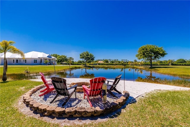 7205 Kamelya St SW, Vero Beach, FL 32968 - exterior space with an outdoor fire pit, a water view, and a lawn