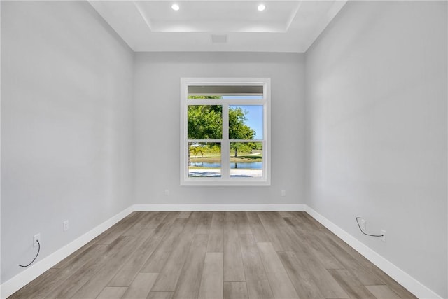 7205 Kamelya St SW, Vero Beach, FL 32968 - unfurnished room with baseboards, wood finished floors, recessed lighting, and a raised ceiling