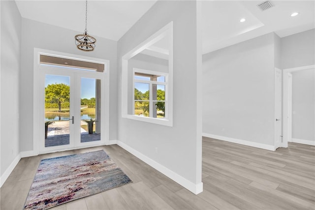7205 Kamelya St SW, Vero Beach, FL 32968 - foyer with french doors, a chandelier, wood finished floors, baseboards, and recessed lighting