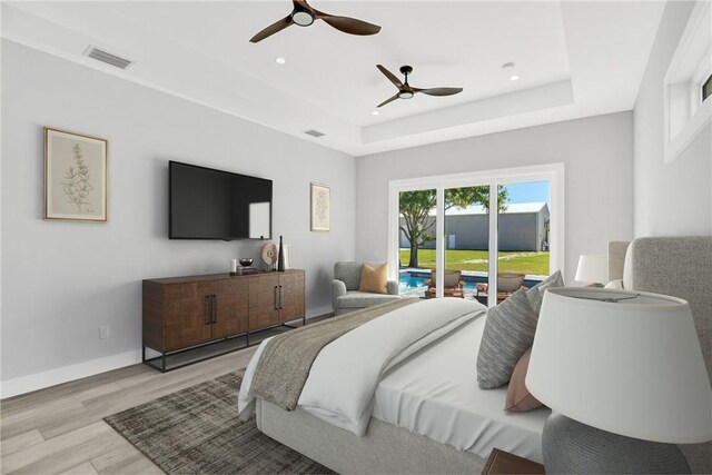 7205 Kamelya St SW, Vero Beach, FL 32968 - bedroom with a raised ceiling, light wood-style floors, access to exterior, and visible vents