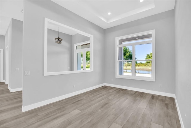 7205 Kamelya St SW, Vero Beach, FL 32968 - empty room with baseboards, wood finished floors, recessed lighting, and a raised ceiling