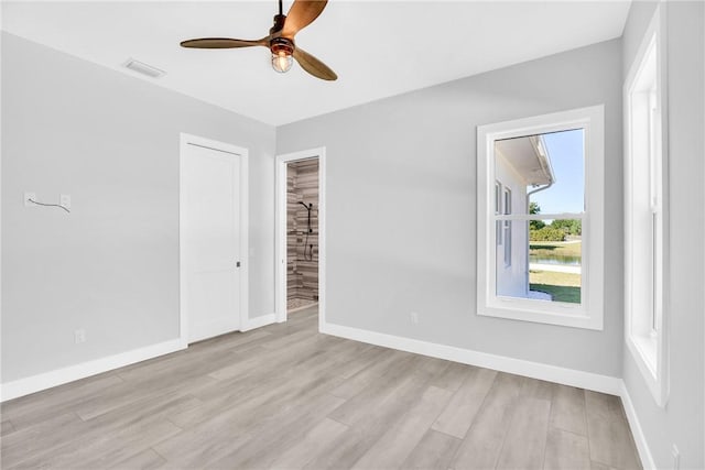 7205 Kamelya St SW, Vero Beach, FL 32968 - empty room with baseboards, visible vents, wood finished floors, and a ceiling fan