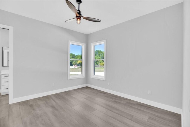 7205 Kamelya St SW, Vero Beach, FL 32968 - spare room with baseboards, wood finished floors, and a ceiling fan