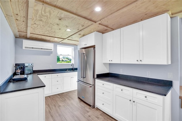7205 Kamelya St SW, Vero Beach, FL 32968 - kitchen featuring a sink, high end refrigerator, light wood-style flooring, dark countertops, and an AC wall unit