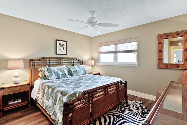 bedroom with dark wood-type flooring, a textured ceiling, and ceiling fan