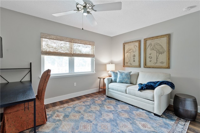 living room with hardwood / wood-style floors, ceiling fan, and a textured ceiling