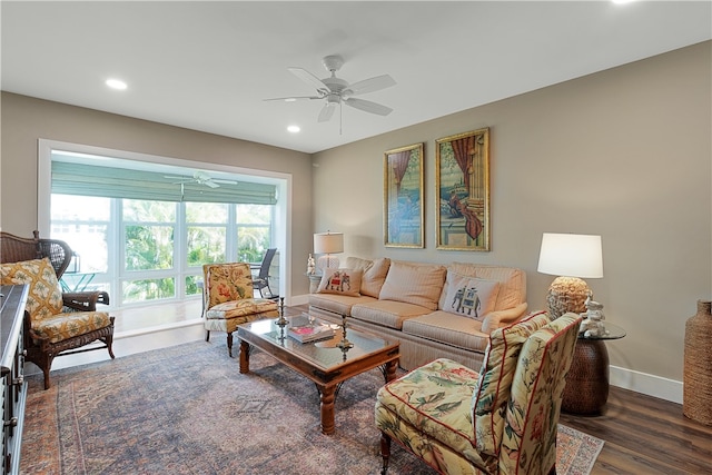 living room with dark hardwood / wood-style flooring and ceiling fan