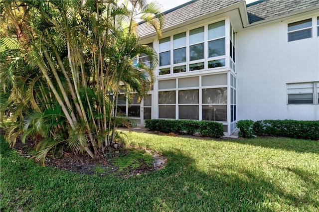 rear view of house featuring a lawn