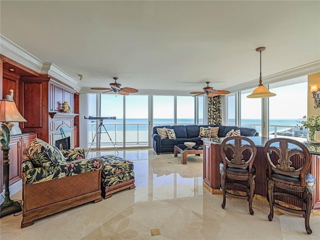 living room featuring ornamental molding, ceiling fan, and a water view