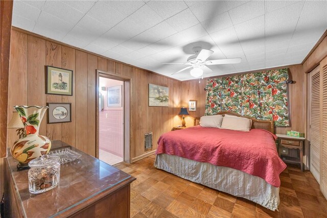 843 22nd Pl, Vero Beach, FL 32960 - bedroom featuring wooden walls and a ceiling fan