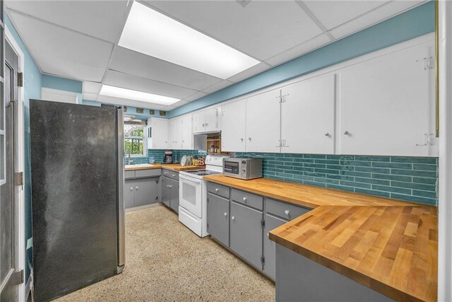 843 22nd Pl, Vero Beach, FL 32960 - kitchen featuring appliances with stainless steel finishes, gray cabinetry, a drop ceiling, butcher block countertops, and backsplash