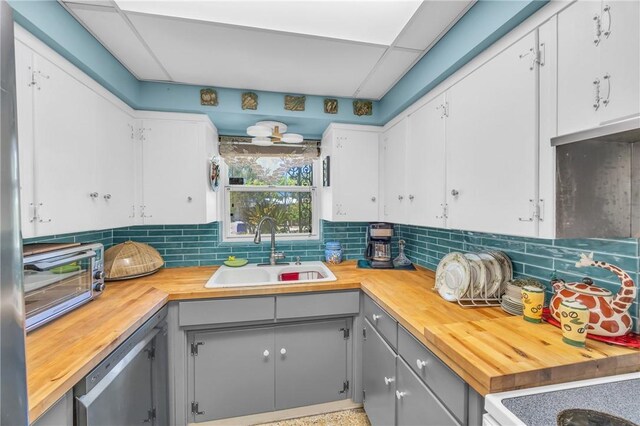 843 22nd Pl, Vero Beach, FL 32960 - kitchen featuring butcher block countertops, gray cabinets, tasteful backsplash, and white cabinetry