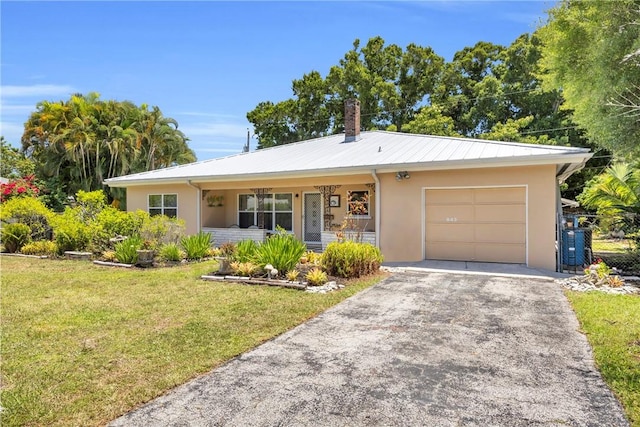 843 22nd Pl, Vero Beach, FL 32960 - single story home with a garage, a front lawn, covered porch, asphalt driveway, and stucco siding