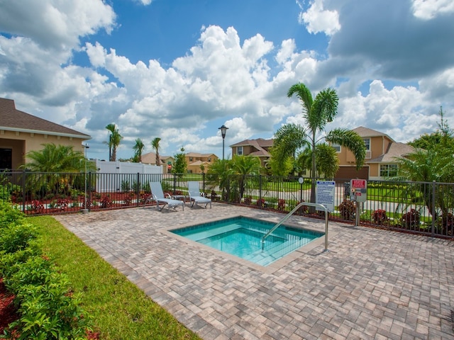 view of pool featuring a community hot tub and a patio