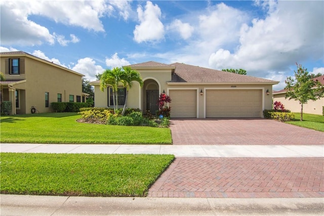 mediterranean / spanish-style house with a garage and a front yard