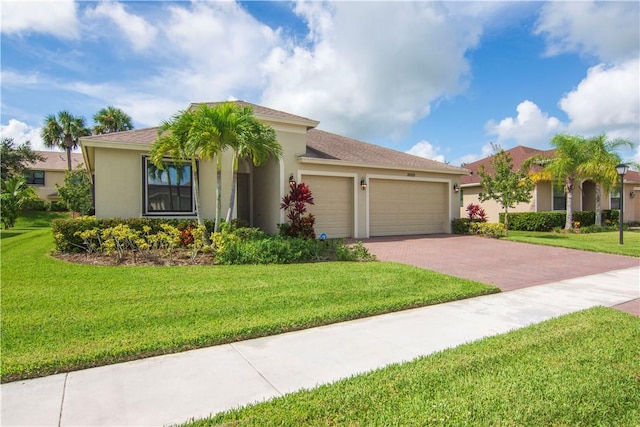 mediterranean / spanish-style home with a garage and a front lawn