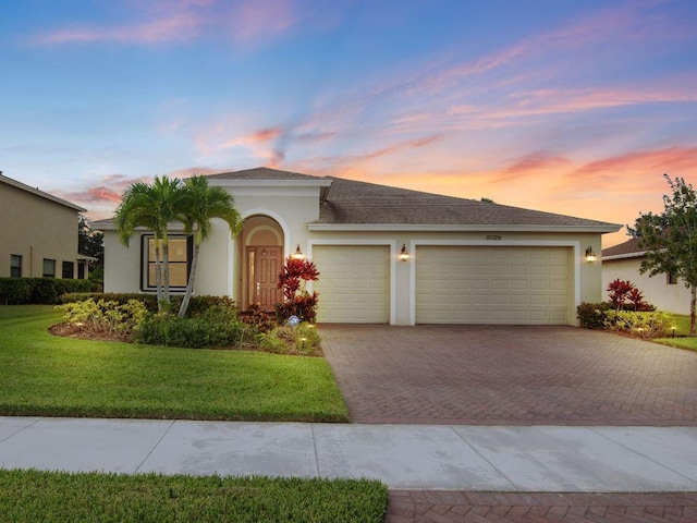 view of front of house with a yard and a garage