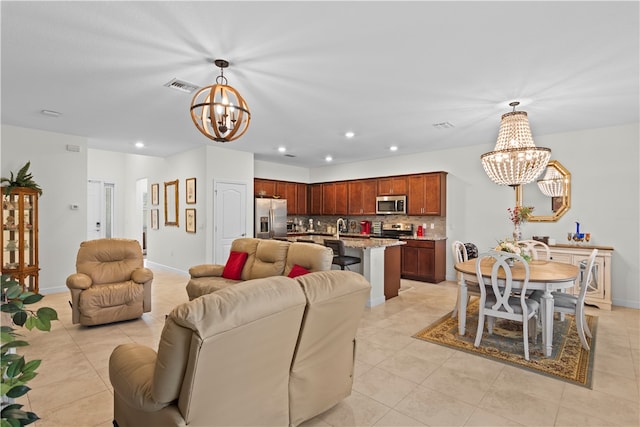 tiled living room with an inviting chandelier