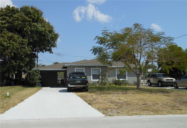 single story home with concrete driveway, a front lawn, and stucco siding