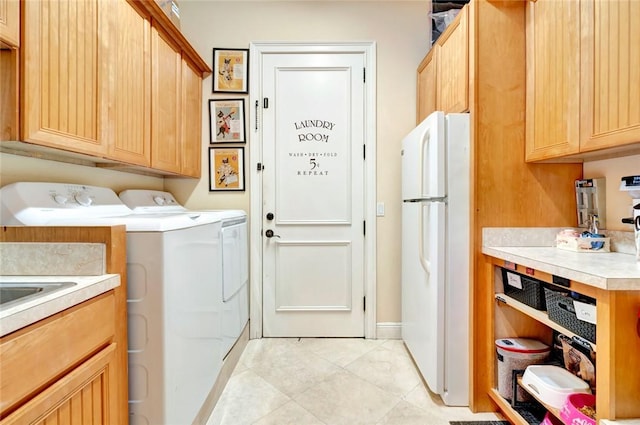 laundry room featuring separate washer and dryer, cabinets, and light tile patterned flooring