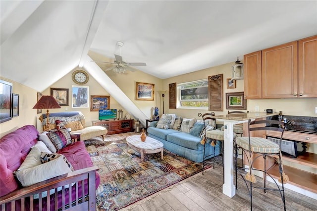 living room featuring vaulted ceiling, ceiling fan, and hardwood / wood-style floors