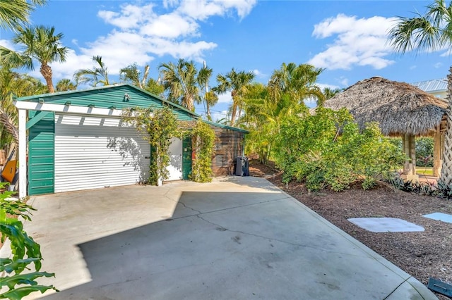 view of patio / terrace with a garage and an outdoor structure