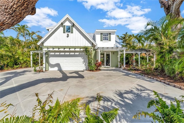 view of front of property with a garage and a pergola