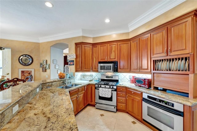 kitchen featuring stainless steel appliances, tasteful backsplash, light stone counters, and kitchen peninsula