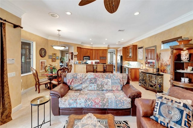 tiled living room featuring ornamental molding and ceiling fan