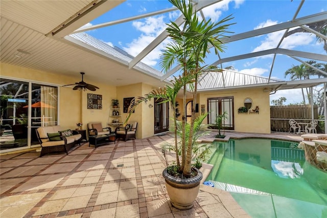 view of swimming pool featuring outdoor lounge area, a lanai, ceiling fan, a patio area, and french doors