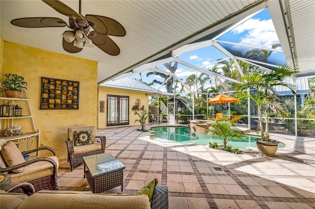 view of pool featuring an in ground hot tub, an outdoor living space, a lanai, and a patio area