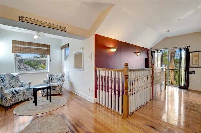 living area featuring vaulted ceiling and light wood-type flooring