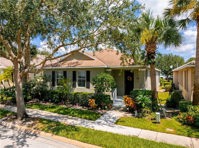 single story home featuring a front yard