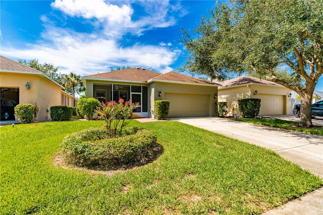 view of front of property featuring a front yard and a garage