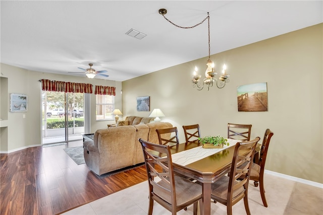 dining room featuring light hardwood / wood-style flooring and ceiling fan with notable chandelier