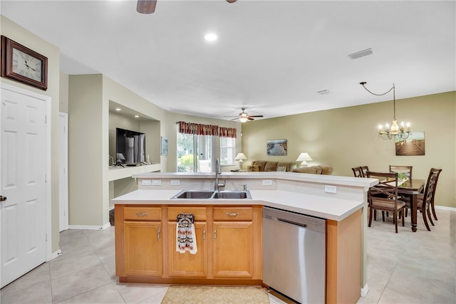 kitchen featuring stainless steel dishwasher, ceiling fan with notable chandelier, a center island with sink, and sink