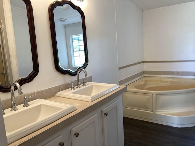 10186 NE 30th St, Okeechobee, FL 34974 - full bath with a garden tub, wood finished floors, and double vanity