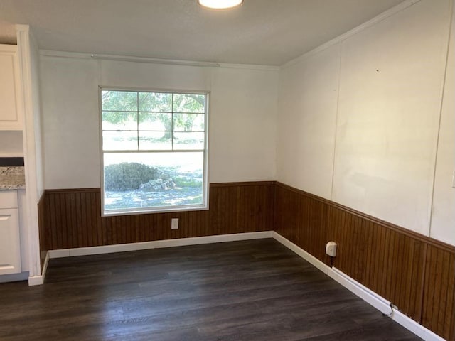 10186 NE 30th St, Okeechobee, FL 34974 - unfurnished room featuring wainscoting, dark wood finished floors, wooden walls, and crown molding