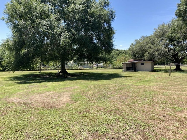 10186 NE 30th St, Okeechobee, FL 34974 - view of green lawn with an outbuilding