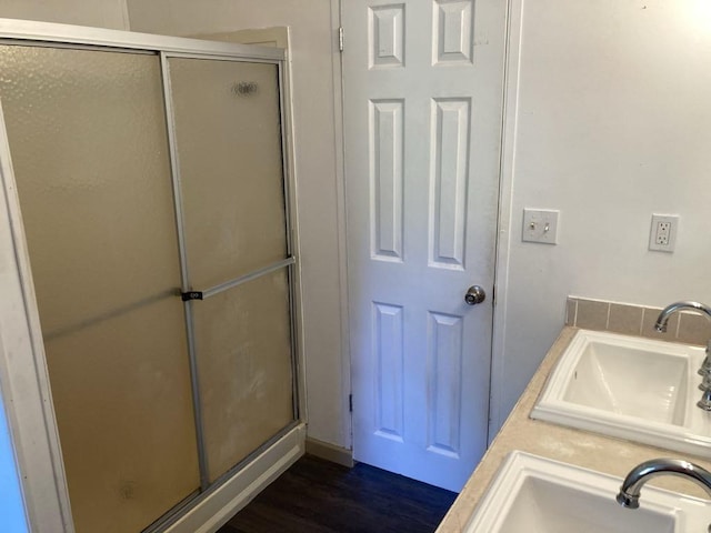 10186 NE 30th St, Okeechobee, FL 34974 - full bathroom with a sink, a shower stall, and wood finished floors