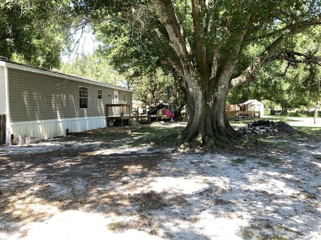 10186 NE 30th St, Okeechobee, FL 34974 - view of yard featuring a wooden deck